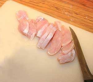 slicing chicken breast meat 